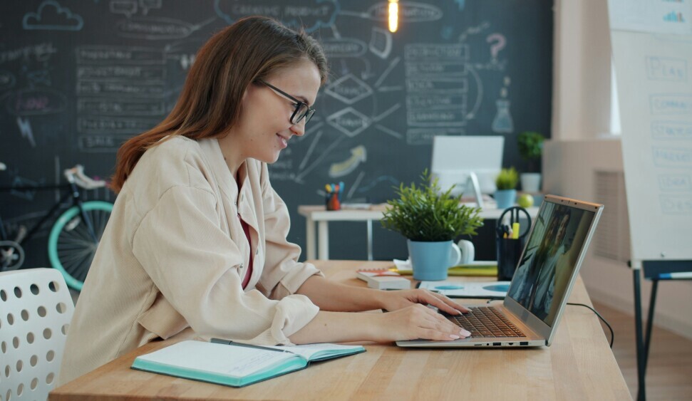 Esl Teacher Using Ai For Lesson Planning At Desk With Laptop